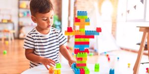 toddler playing with building blocks