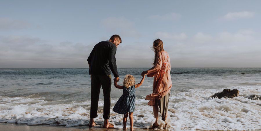 mom and dad take kid to beach