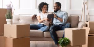 smiling-black-couple-use-digital-tablet-on-moving-day-picture-id1158481661.jpg